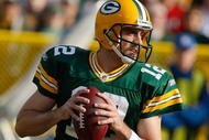 GREEN BAY, WI - NOVEMBER 22: Quarterback Aaron Rodgers #12 of the Green Bay Packers passes the football against the San Francisco 49ers at Lambeau Field on November 22, 2009 in Green Bay, Wisconsin. The Packers defeated the 49ers 30-24. (Photo by Scott Boehm/Getty Images)