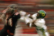 CORVALIS, OR - NOVEMBER 23: Charles Favroth #11 of the University of Oregon Ducks attempts to tackle Shawn Jackson #34 of the Oregon State University Beavers during the 'Civil War' game at Reser Stadium on November 23, 2003 in Corvalis, Oregon. Oregon State won 45-24. (Photo by Jon Ferrey/Getty Images)
