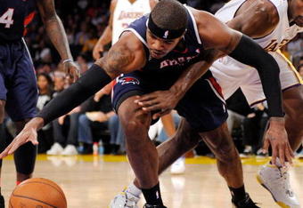 LOS ANGELES, CA - NOVEMBER 01: Ron Artest #37 of the Los Angeles Lakers forces a turn over against Josh Smith #5 of the Atlanta Hawks during the NBA basketball game at Staples Center on November 1, 2009 in Los Angeles, California. NOTE TO USER: User expressly acknowledges and agrees that, by downloading and/or using this Photograph, user is consenting to the terms and conditions of the Getty Images License Agreement. (Photo by Kevork Djansezian/Getty Images)