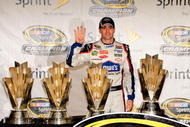 HOMESTEAD, FL - NOVEMBER 22:  Jimmie Johnson, driver of the #48 Lowe's Chevrolet, poses with all four of his championship trophies after winning the NASCAR Sprint Cup Series Championship at Homestead-Miami Speedway on November 22, 2009 in Homestead, Florida. Johnson becomes the first driver in the history of NASCAR to win four consecutive championships since the sports inception in 1949.  (Photo by Sam Greenwood/Getty Images)