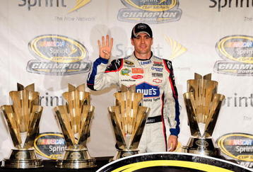 HOMESTEAD, FL - NOVEMBER 22:  Jimmie Johnson, driver of the #48 Lowe's Chevrolet, poses with all four of his championship trophies after winning the NASCAR Sprint Cup Series Championship at Homestead-Miami Speedway on November 22, 2009 in Homestead, Florida. Johnson becomes the first driver in the history of NASCAR to win four consecutive championships since the sports inception in 1949.  (Photo by Sam Greenwood/Getty Images)