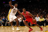 LOS ANGELES, CA - NOVEMBER 15:  Trevor Ariza #1 of  the Houston Rockets drives against Ron Artest #37 of the Los Angeles Lakers on November 15, 2009 at Staples Center in Los Angeles, California.  The Rockets won 101-91.  NOTE TO USER: User expressly acknowledges and agrees that, by downloading and/or using this Photograph, user is consenting to the terms and conditions of the Getty Images License Agreement.  (Photo by Stephen Dunn/Getty Images)