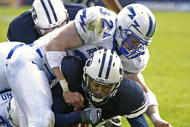 PROVO, UT - OCTOBER 29:  John Rabold #32 and Brad Meissen #36 of Air Force tackle Michael Reed (C) of Brigham Young University during the second quarter October 29, 2005 at LaVell Edwards Stadium in Provo, Utah.  (Photo by George Frey/Getty Images)