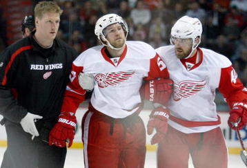 MONTREAL- NOVEMBER 21:  Niklas Kronwall #55 of the Detroit Red Wings is helped off of the ice after being tripped by Georges Laraque #17 of the Montreal Canadiens during the NHL game on November 21, 2009 at the Bell Centre in Montreal, Quebec, Canada.  (Photo by Richard Wolowicz/Getty Images)