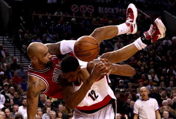 PORTLAND, OR - NOVEMBER 19:  Drew Gooden #90 of the Chicago Bulls falls over the top of LaMarcus Aldridge #12 of the Portland Trail Blazers  at the Rose Garden November 18, 2008 in Portland, Oregon.  NOTE TO USER: User expressly acknowledges and agrees that, by downloading and or using this Photograph, user is consenting to the terms and conditions of the Getty Images License Agreement.  (Photo by Jonathan Ferrey/Getty Images)