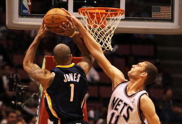 EAST RUTHERFORD, NJ - NOVEMBER 17:  Brook Lopez #11 of the New Jersey Nets blocks a shot by Dahntay Jones #1  of The Indiana Pacers during their game on November 17, 2009 at The Izod Center in East Rutherford, New Jersey.  NOTE TO USER: User expressly acknowledges and agrees that, by downloading and/or using this Photograph, user is consenting to the terms and conditions of the Getty Images License Agreement.  (Photo by Al Bello/Getty Images)