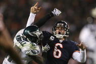 CHICAGO - NOVEMBER 22: Jay Cutler #6 of the Chicago Bears is hit by Quintin Mikell #27 of the Philadelphia Eagles as Cutler throws a 15-yard touchdown in the third quarter at Soldier Field on November 22, 2009 in Chicago, Illinois.  (Photo by Jonathan Daniel/Getty Images)