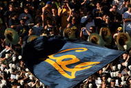 PASADENA, CA - OCTOBER 17:  A California Golden Bears cheerleader waves a flag in front of the Cal band and visitor's section in the game with the UCLA Bruins on October 17, 2009 at the Rose Bowl in Pasadena, California.   Cal won 45-26.  (Photo by Stephen Dunn/Getty Images)