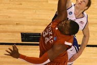 GREENSBORO, NC - MARCH 21: Kyle Singler #12 of the Duke Blue Devils defends the basket against Dexter Pittman #34 of the Texas Longhorns during the second round of the NCAA Division I Men's Basketball Tournament at the Greensboro Coliseum on March 21, 2009 in Greensboro, North Carolina. (Photo by Streeter Lecka/Getty Images)