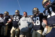 SOUTH BEND, IN - NOVEMBER 21: Head coach Charlie Weis of the Notre Dame Fighting Irish waits to enter the field with (L-R) Jimmy Clausen #7, Eric Olsen #55, Kyle McCarthy #28 and Scott Smith #41 before a game against the University of Connecticut Huskies at Notre Dame Stadium on November 21, 2009 in South Bend, Indiana. (Photo by Jonathan Daniel/Getty Images)