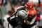 OAKLAND, CA - NOVEMBER 22:  Carson Palmer #9 of the Cincinnati Bengals is hit by Gerard Warren #61 of the Oakland Raiders at Oakland-Alameda County Coliseum on November 22, 2009 in Oakland, California.  (Photo by Ezra Shaw/Getty Images)