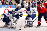 TORONTO - NOVEMBER 21: Vesa Toskala #35, Ian White #7 and Francois Beauchemin #22 of the Toronto Maple Leafs grab the loose puck before Tomas Fleischmann #14 of the Washington Capitals during game action November 21, 2009 at the Air Canada Centre in Toronto, Ontario, Canada. (Photo by Abelimages/Getty Images)