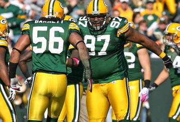 GREEN BAY, WI - OCTOBER 18: Johnny Jolly #97 and  Nick Barnett #56 of the Green Bay Packers celebrate a defensive stop against the Detroit Lions at Lambeau Field on October 18, 2009 in Green Bay, Wisconsin. The Packers defeated the Lions 26-0. (Photo by Jonathan Daniel/Getty Images)