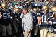 SOUTH BEND, IN - NOVEMBER 21: Head coach Charlie Weis of the Notre Dame Fighting Irish wipes a tear from his eye before lining up to enter the field for a game against the University of Connecticut Huskies at Notre Dame Stadium on November 21, 2009 in South Bend, Indiana. (Photo by Jonathan Daniel/Getty Images
