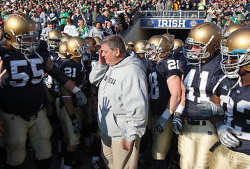 SOUTH BEND, IN - NOVEMBER 21: Head coach Charlie Weis of the Notre Dame Fighting Irish wipes a tear from his eye before lining up to enter the field for a game against the University of Connecticut Huskies at Notre Dame Stadium on November 21, 2009 in South Bend, Indiana. (Photo by Jonathan Daniel/Getty Images