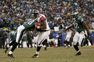 PHILADELPHIA - JANUARY 23:  Tightend Alge Crumpler #83 of the Atlanta Falcons is hit by Brian dawkins #20 of the Philadelphia Eagles in the second quarter during the NFC Championship game at Lincoln Financial Field on January 23, 2005 in Philadelphia, Pennsylvannia.  (Photo by Brian Bahr/Getty Images)