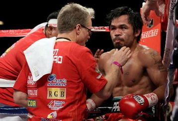 LAS VEGAS - NOVEMBER 14:  Manny Pacquiao sits in his corner between rounds with trainer Freddie Roach against Miguel Cotto during their WBO welterweight title fight at the MGM Grand Garden Arena on November 14, 2009 in Las Vegas, Nevada.  (Photo by Al Bello/Getty Images)