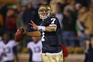 SOUTH BEND, IN - NOVEMBER 21: Jimmy Clausen #7 of the Notre Dame Fighting Irish looks for a receiver in the first overtime period against the Univeristy of Connecticut Huskies at Notre Dame Stadium on November 21, 2009 in South Bend, Indiana. Connecticut defeated Notre Dame 33-30 in double overtime. (Photo by Jonathan Daniel/Getty Images)
