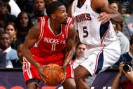 ATLANTA - NOVEMBER 20:  Josh Smith #5 of the Atlanta Hawks defends against Aaron Brooks #0 of the Houston Rockets at Philips Arena on November 20, 2009 in Atlanta, Georgia.  NOTE TO USER: User expressly acknowledges and agrees that, by downloading and/or using this Photograph, User is consenting to the terms and conditions of the Getty Images License Agreement.  (Photo by Kevin C. Cox/Getty Images)