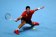 LONDON, ENGLAND - NOVEMBER 23:  Novak Djokovic of Serbia returns the ball during the men's singles first round match against Nikolay Davydenko of Russia  during the Barclays ATP World Tour Finals at the O2 Arena on November 23, 2009 in London, England.  (Photo by Julian Finney/Getty Images)