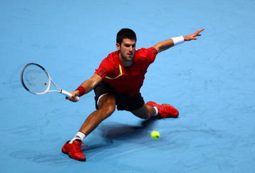 LONDON, ENGLAND - NOVEMBER 23:  Novak Djokovic of Serbia returns the ball during the men's singles first round match against Nikolay Davydenko of Russia  during the Barclays ATP World Tour Finals at the O2 Arena on November 23, 2009 in London, England.  (Photo by Julian Finney/Getty Images)