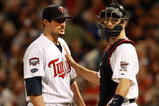 MINNEAPOLIS, MN - OCTOBER 11: Pitcher Carl Pavano #48 of the Minnesota Twins talks with catcher Joe Mauer #2 after Jorge Posada  the New York Yankees hit a home run in the seventh inning to take a 2-1 lead in Game Three of the ALDS during the 2009 MLB Playoffs at the Hubert H. Humphrey Metrodome on October 11, 2009 in Minneapolis, Minnesota. (Photo by Genevieve Ross/Getty Images)