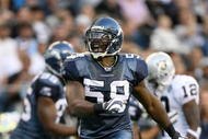 SEATTLE - SEPTEMBER 03:  Linebacker Aaron Curry #59 of the Seattle Seahawks celebrates after tackling running back Michael Bush #29 of the Oakland Raiders on September 3, 2009 at Qwest Field in Seattle, Washington. The Seahawks defeated the Raiders 31-21. (Photo by Otto Greule Jr/Getty Images)