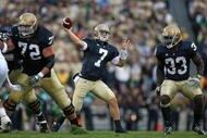 SOUTH BEND, IN - OCTOBER 03: Jimmy Clausen #7 of the Notre Dame Fighting Irish passes the ball as teammates Paul Duncan #72 and Robert Hughes #33 look to block against the Washington Huskies on October 3, 2009 at Notre Dame Stadium in South Bend, Indiana. Notre Dame defeated Washington 37-30 in overtime. (Photo by Jonathan Daniel/Getty Images)
