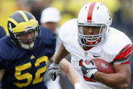 ANN ARBOR, MI - NOVEMBER 21:  Brandon Saine #3 of the Ohio State Buckeyes runs for a second quarter touchdown in front of Kevin Leach #52 of the Michigan Wolverines on November 21, 2009 at Michigan Stadium in Ann Arbor, Michigan.  (Photo by Gregory Shamus/Getty Images)