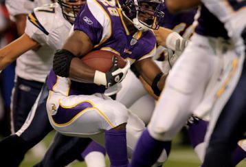 MINNEAPOLIS, MN - NOVEMBER 04:  Adrian Peterson #28 of the Minnesota Vikings runs the ball as he set two NFL records against the San Diego Chargers at the Hubert H. Humphrey Metrodome on November 4, 2007 in Minneapolis, Minnesota. Peterson rushed for 296 yards setting the single game rushing record and marks the first time a rookie has rushed for two 200 yard games in the same season. The Vikings defeated the Chargers 35-17.  (Photo by Doug Pensinger/Getty Images)