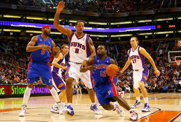 PHOENIX - NOVEMBER 22:  Will Bynum #12 of the Detroit Pistons drives the ball past Channing Frye #8 of the Phoenix Suns during the NBA game at US Airways Center on November 22, 2009 in Phoenix, Arizona. The Suns defeated the Pistons 117-91. NOTE TO USER: User expressly acknowledges and agrees that, by downloading and or using this photograph, User is consenting to the terms and conditions of the Getty Images License Agreement.  (Photo by Christian Petersen/Getty Images)