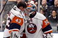 TORONTO - NOVEMBER 23:  Martin Biron #43 congratulates Dwayne Roloson #30 of the New York Islanders on stopping 61 shots to win the game 4-3 in OT against the Toronto Maple Leafs during game action November 23, 2009 at the Air Canada Centre in Toronto, Ontario, Canada. (Photo by Abelimages/Getty Images)