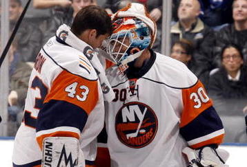 TORONTO - NOVEMBER 23:  Martin Biron #43 congratulates Dwayne Roloson #30 of the New York Islanders on stopping 61 shots to win the game 4-3 in OT against the Toronto Maple Leafs during game action November 23, 2009 at the Air Canada Centre in Toronto, Ontario, Canada. (Photo by Abelimages/Getty Images)