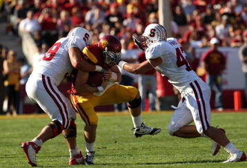 LOS ANGELES - NOVEMBER 14: Defensive tackle Matthew Masifilo #98 and linebacker Will Powers #42 of the Stanford Cardinal tackle quarterback Matt Barkley #7 of the USC Trojans on November 14, 2009 at the Los Angeles Coliseum in Los Angeles, California.  Stanford won 55-21.   (Photo by Stephen Dunn/Getty Images)