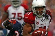 CHICAGO - NOVEMBER 08: Larry Fitzgerald #11 of the Arizona Cardinals shakes off a tackle attempt by Charles Tillman #33 of the Chicago Bears to score a touchdown at Soldier Field on November 8, 2009 in Chicago, Illinois. The aCardinals defeated the Bears 41-21. (Photo by Jonathan Daniel/Getty Images)