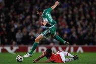 MANCHESTER, ENGLAND - SEPTEMBER 30:  Edin Dzeko of VfL Wolfsburg hurdles the challenge of Patrice Evra of Manchester United during the UEFA Champions League Group B match between Manchester United and VfL Wolfsburg at Old Trafford on September 30, 2009 in Manchester, England.  (Photo by Michael Regan/Getty Images)