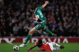 MANCHESTER, ENGLAND - SEPTEMBER 30:  Edin Dzeko of VfL Wolfsburg hurdles the challenge of Patrice Evra of Manchester United during the UEFA Champions League Group B match between Manchester United and VfL Wolfsburg at Old Trafford on September 30, 2009 in Manchester, England.  (Photo by Michael Regan/Getty Images)