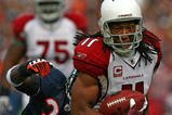 CHICAGO - NOVEMBER 08: Larry Fitzgerald #11 of the Arizona Cardinals shakes off a tackle attempt by Charles Tillman #33 of the Chicago Bears to score a touchdown at Soldier Field on November 8, 2009 in Chicago, Illinois. The aCardinals defeated the Bears 41-21. (Photo by Jonathan Daniel/Getty Images)