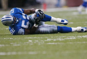 DETROIT - OCTOBER 20:  Linebacker Richard Jordan #52 of the Detroit Lions holds his left knee in pain as he lies on the field after the play during the NFL game against the Chicago Bears at Ford Field on October 20, 2002 in Detroit, Michigan. The Lions beat the Bears in overtime 23-20.  (Photo by Danny Moloshok/Getty Images)