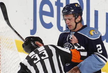 SUNRISE, FL - NOVEMBER 23: Keith Ballard #2 of the Florida Panthers has his mouth checked by referee Kevin Pollock #33 after he was hit by Sidney Crosby #87 (not pictured) of the Pittsburgh Penguins on November 23, 2009 at the BankAtlantic Center in Sunrise, Florida. (Photo by Joel Auerbach/Getty Images)