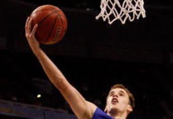 TAMPA, FL - MARCH 13:  Nick Calathes #33 of the Florida Gators makes a layup over Quantez Robertson #23 of the Auburn Tigers during the quaterfinal round of the SEC Men's Basketball Tournament on March 13, 2009 at The St. Pete Times Forum in Tampa, Florida.  (Photo by Chris Graythen/Getty Images)