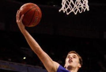 TAMPA, FL - MARCH 13:  Nick Calathes #33 of the Florida Gators makes a layup over Quantez Robertson #23 of the Auburn Tigers during the quaterfinal round of the SEC Men's Basketball Tournament on March 13, 2009 at The St. Pete Times Forum in Tampa, Florida.  (Photo by Chris Graythen/Getty Images)