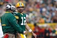 GREEN BAY, WI - NOVEMBER 22: Quarterback Aaron Rogers #12 of the Green Bay Packers talks with head coach Mike McCarthy against the San Francisco 49ers at Lambeau Field on November 22, 2009 in Green Bay, Wisconsin. The Packers defeated the 49ers 30-24. (Photo by Scott Boehm/Getty Images)