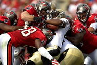 TAMPA, FL - NOVEMBER 22:  Running back Mike Bell #21 of the New Orleans Saints is tackled by the Tampa Bay Buccaneers defense during the game at Raymond James Stadium on November 22, 2009 in Tampa, Florida.  (Photo by J. Meric/Getty Images)