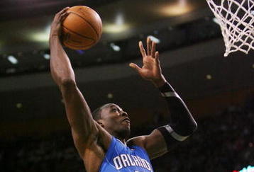 BOSTON - NOVEMBER 20: Dwight Howard #12 of the Orlando Magic dunks the ball and gets fouled by Rajon Rondo (not pictured) of the Boston Celtics during the game on November 20, 2009 at the TD Garden in Boston, Massachusetts. NOTE TO USER: User expressly acknowledges and agrees that, by downloading and or using this photograph, User is consenting to the terms and conditions of the Getty Images License Agreement.  (Photo by Elsa/Getty Images)