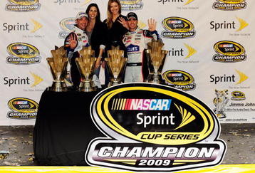 HOMESTEAD, FL - NOVEMBER 22:  Crew chief Chad Knaus, (L) girlfriend Lisa Rockelmann (2nd-L), Jimmie Johnson (R), driver of the #48 Lowe's Chevrolet, poses with his wife Chandra and all four of his trophies after winning the NASCAR Sprint Cup Series Championship after finishing in fifth place in the Ford 400 at Homestead-Miami Speedway on November 22, 2009 in Homestead, Florida. Johnson becomes the first driver in the history of NASCAR to win four consecutive championships since the sports inception in 1949.during the NASCAR Sprint Cup Series Ford 400 at Homestead-Miami Speedway on November 22, 2009 in Homestead, Florida.  (Photo by Sam Greenwood/Getty Images)