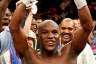 LAS VEGAS - SEPTEMBER 19: Floyd Mayweather Jr., with his advisor Leonard Ellerbe behind him, celebrates his unanimous-decision victory over Juan Manuel Marquez at the MGM Grand Garden Arena September 19, 2009 in Las Vegas, Nevada. (Photo by Ethan Miller/Getty Images)