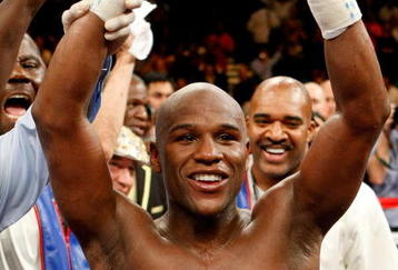 LAS VEGAS - SEPTEMBER 19:  Floyd Mayweather Jr., with his advisor Leonard Ellerbe behind him, celebrates his unanimous-decision victory over Juan Manuel Marquez at the MGM Grand Garden Arena September 19, 2009 in Las Vegas, Nevada.  (Photo by Ethan Miller/Getty Images)