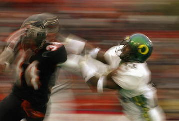 CORVALIS, OR - NOVEMBER 23:  Charles Favroth #11 of the University of Oregon Ducks attempts to tackle Shawn Jackson #34 of the Oregon State University Beavers during the 'Civil War' game at Reser Stadium on November 23, 2003 in Corvalis, Oregon. Oregon State won 45-24.  (Photo by Jon Ferrey/Getty Images) 