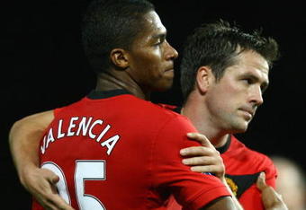 MANCHESTER, ENGLAND - NOVEMBER 21:  Antonio Valencia of Manchester United is congratulated by team mate Michael Owen after scoring his team's third goal during the Barclays Premier League match between Manchester United and Everton at Old Trafford on November 21, 2009 in Manchester, England.  (Photo by Alex Livesey/Getty Images)